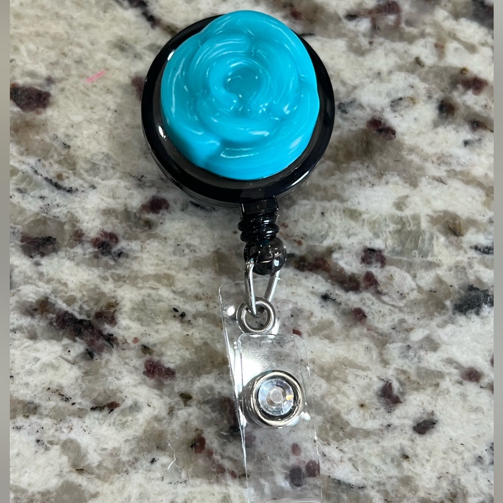 Blue teal flower and diamond badge reel.
